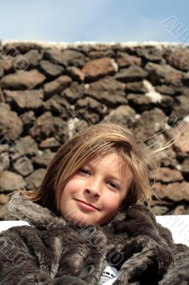 Happy girl in a fur coat in the winter
