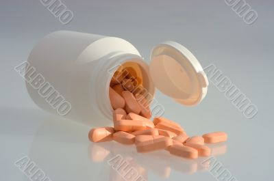 Medicine pills with a white bottle