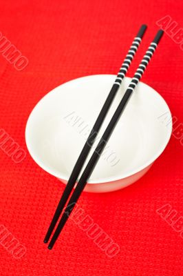 Pair of chopsticks and white bowl
