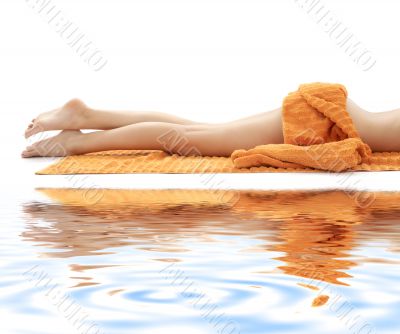 long legs with orange towel on white sand 3