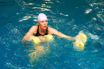 Girl in water with dumbbels