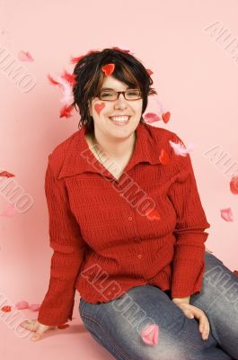 young woman surrounded by hearts and feathers