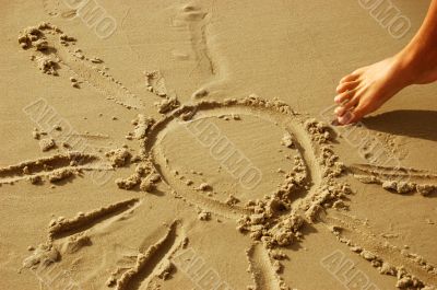 Sun drawing on sand