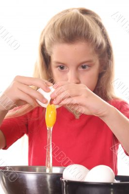 little girl cracking an egg