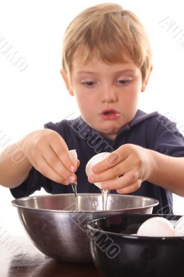 little boy cracking an egg
