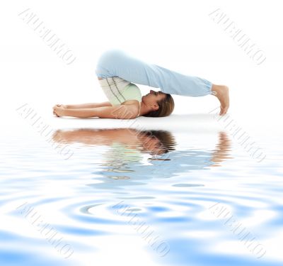 halasana plow pose on white sand #2