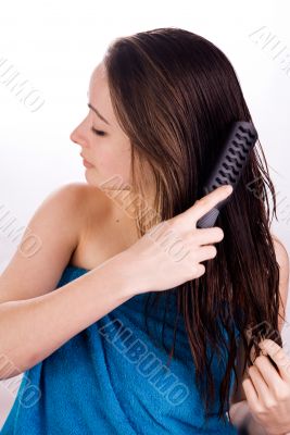 Woman is grooming her hair