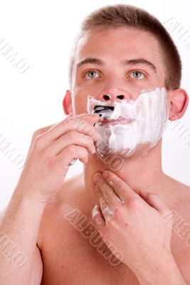 Young man is shaving