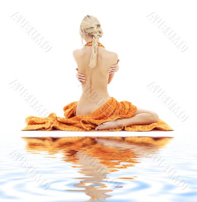 beautiful lady with orange towels on white sand 2