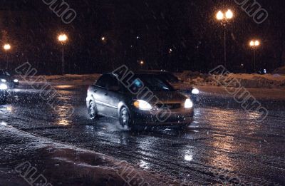 Cars in night blizzard.