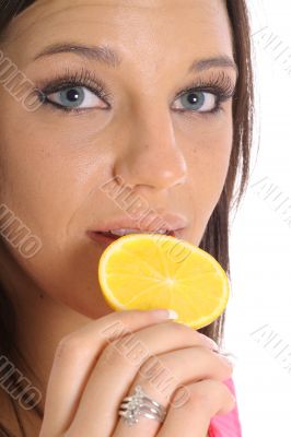 model eating an orange slice upclose