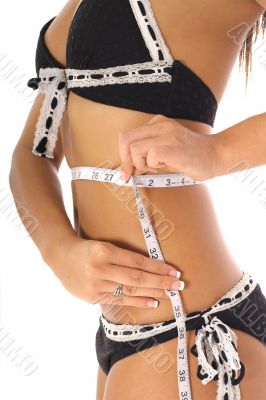 woman taking measurements in a bikini