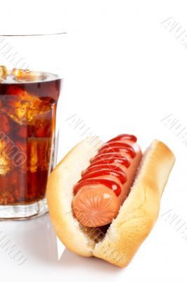 A hot dog and soda glass