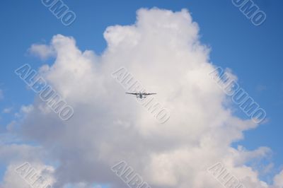 Plane on a blue and cloudy sky
