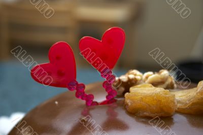 Glazed chocolate cake with two red lovely hearts