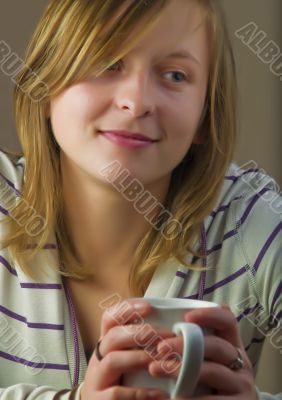 Girl drinking coffee and smiling