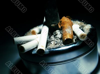 Ashtray with cigarettes and a cigar