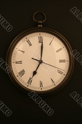 pocketwatch style clock on black background