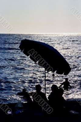 under a beach umbrella