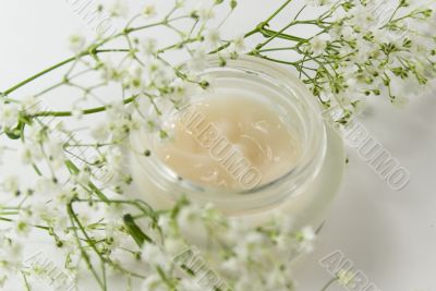 face creme and white flowers