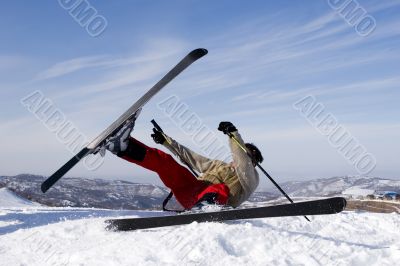 Snow Skier Jumping Against Blue Sky