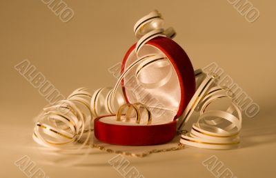 Close up of wedding bands over gold background