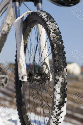 Bike in winter over blue sky