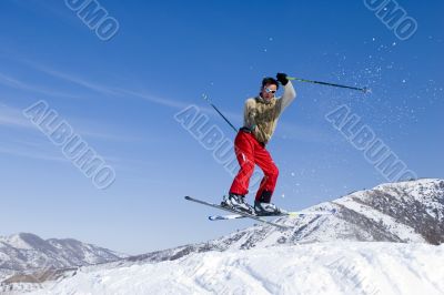 Snow Skier Jumping Against Blue Sky