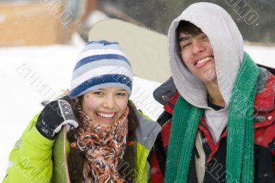 A lifestyle image of two young snowboarders