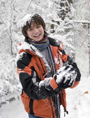 boy in scarf with snowball