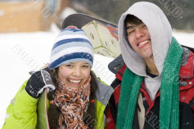 A lifestyle image of two young snowboarders