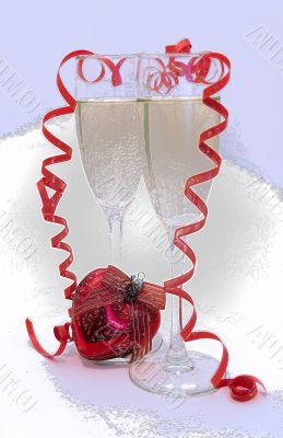 glass of a rose champagne and frozen red heart
