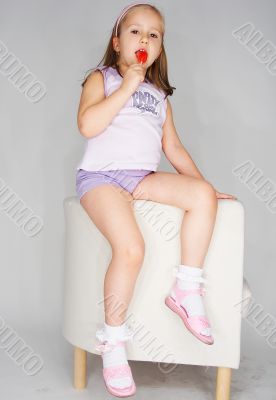 Nice young girl in pink on light background