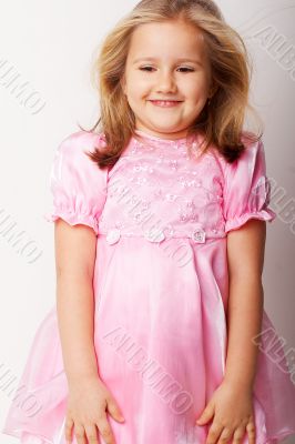 Nice young girl in pink on light background