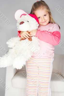 Nice young girl in pink on light background
