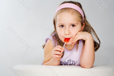Nice young girl in pink on light background