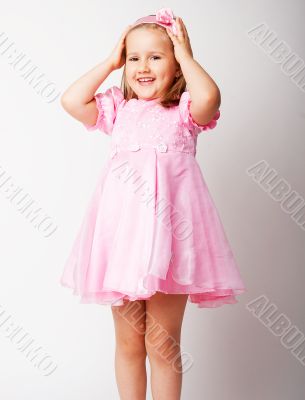 Nice young girl in pink on light background