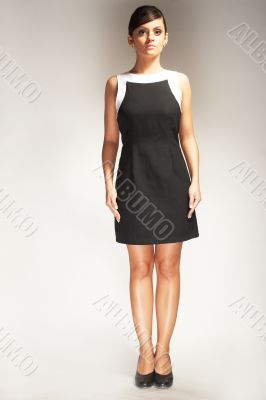 Fashion model Posed on light background in black dress