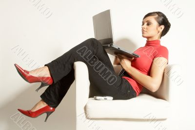 Atractive brunet businesswoman with Laptop and phone