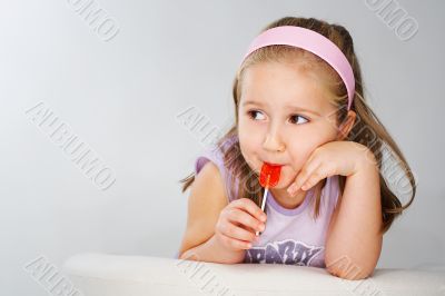 Nice young girl in pink on light background