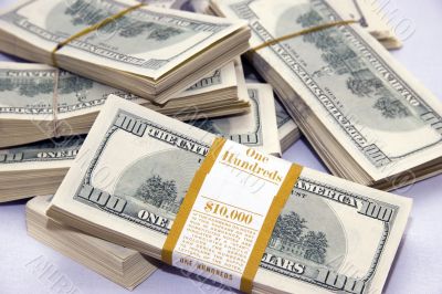 table full of 100 dollar bills