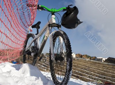 Bike in winter over blue sky