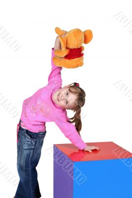The child holds a toy in a hand
