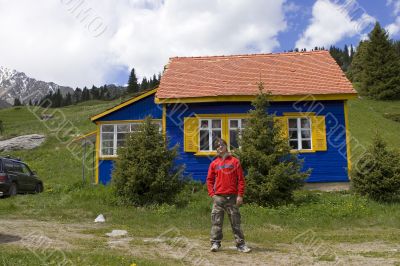 Man near to mountain house