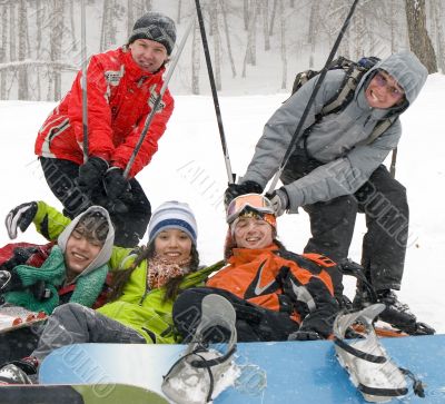 Happy snowboarding team in mountains