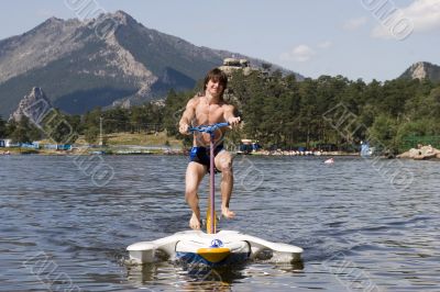 Teenager ride by water bicycle