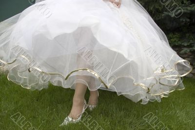 beautiful legs and white skirt of wedding dress