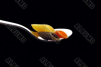 italian penne pasta on a spoon