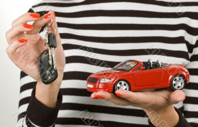 Car and keys in hands