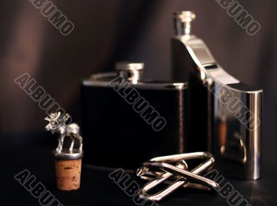 Metallic things: flasks, puzzle and cork